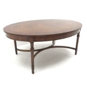 Wade Georgian style oval coffee table, turned tapering reeded supports joind by shaped 'X' framed st