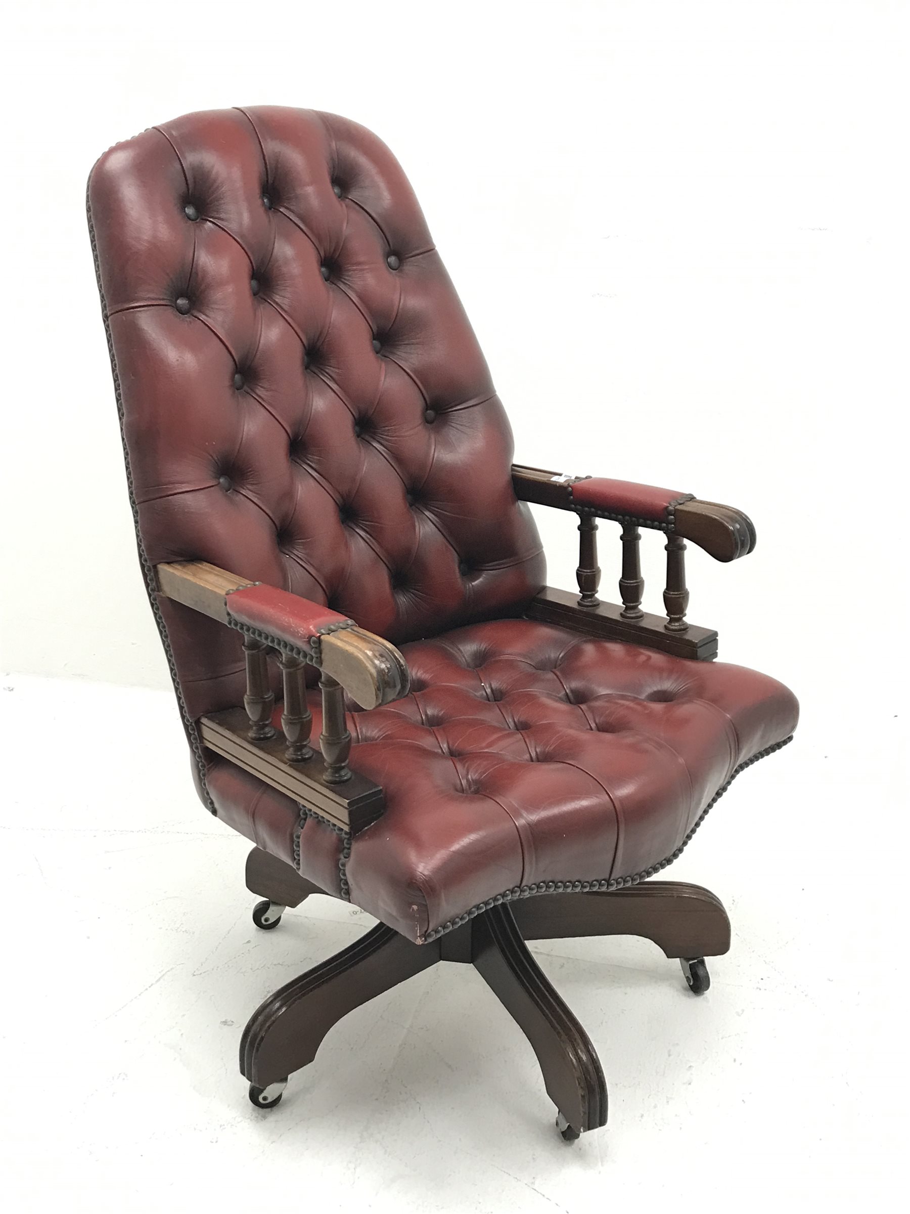 Swivel reclining desk chair upholstered in deep buttoned oxblood leather, W60cm