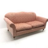 Wesley Barrell Hinton two seat sofa, shaped cresting rail, scrolling arms, turned supports on castor