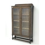 Early 20th century oak bookcase enclosed by two lead glazed doors, fitted with three adjustable shel