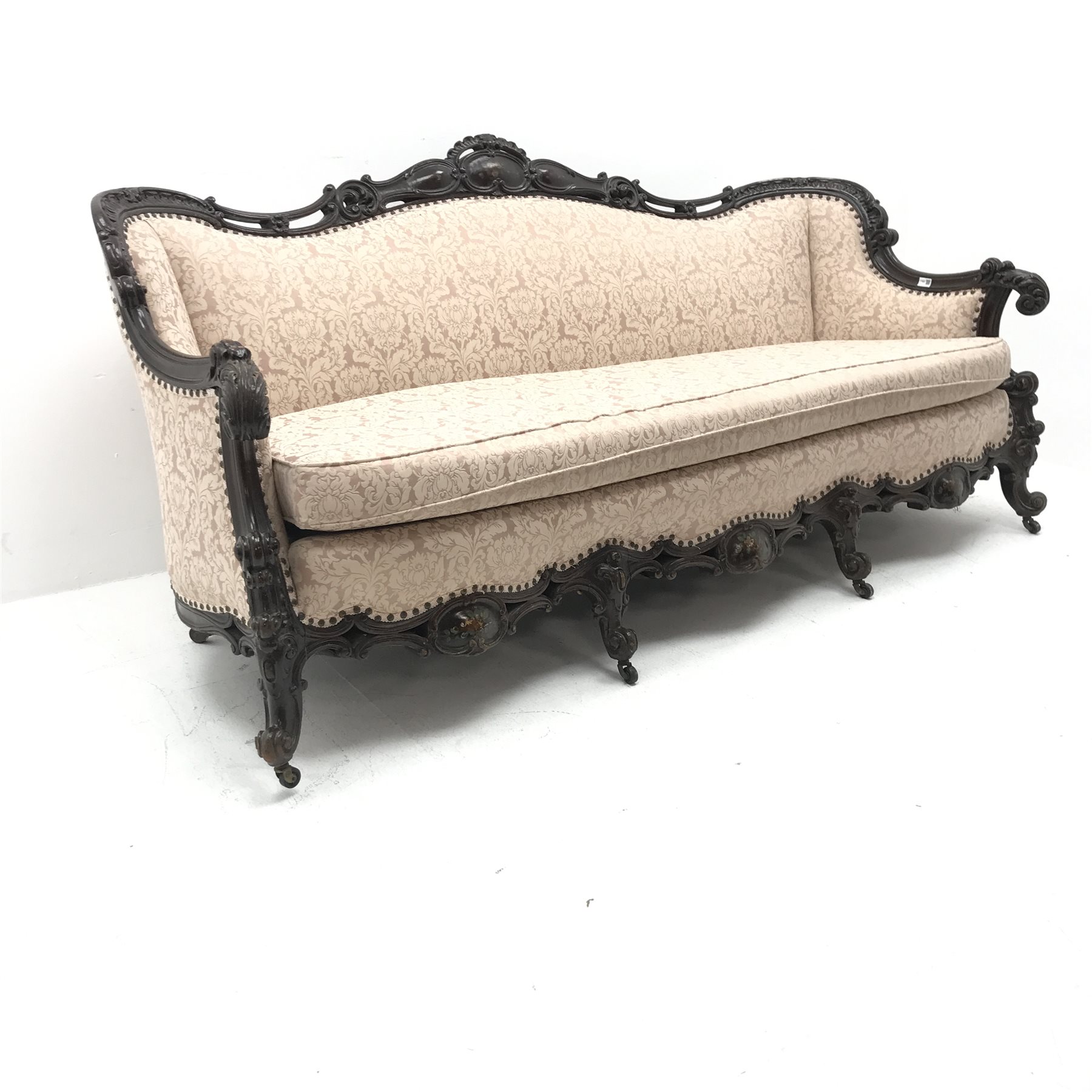 French style carved walnut framed three seat sofa upholstered in alight pink fabric with floral patt