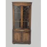 Reproduction Bevan Funnell mahogany double corner cabinet, projecting dentil cornice, two doors encl
