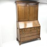 Georgian oak bureau bookcase, projecting cornice, two cupboards above fall front enclosing well fitt