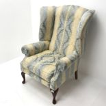 Wing back armchair upholstered in light blue and pale gold striped fabric, cabriole feet, W85cm