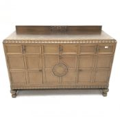 E. Gomme Ltd of High Wycombe oak sideboard, raised carved back, moulded top, three drawers above two