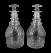 Pair of early 19th century decanters of mallet form, with part sliced and cut decoration, triple fac