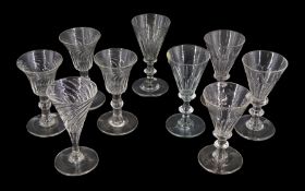 Nine 19th century drinking glasses with wrythen twist and part fluted bowls