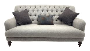 Traditional shaped three seat sofa upholstered in buttoned Harris Tweed fabric, turned front support