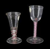 18th century drinking glass, the funnel bowl upon a double series opaque colour twist stem with red