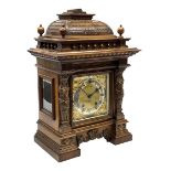 Late 19th century walnut cased architectural mantel clock, caddy pediment carved with tile effect ra