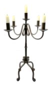 A patinated wrought iron five branch candelabra