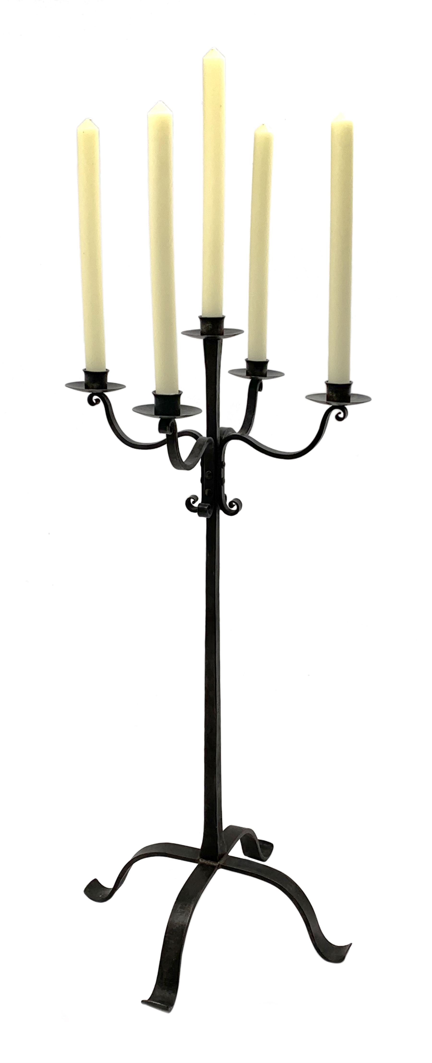 Wrought hand forged iron candle stand, four scrolled branches and central vertical branch with sconc