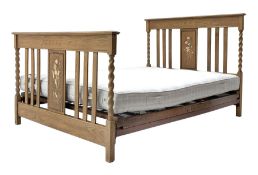 Early to mid 20th century oak 4' 6'' double bedstead, the head and footboards with barley twist supp