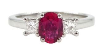 Platinum three stone oval ruby and round brilliant cut diamond ring