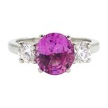 Platinum three stone oval pink sapphire and round brilliant cut diamond ring