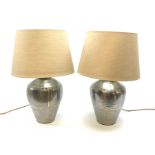 A pair of brushed steel table lamps