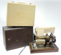 Two cased singer sewing machines.