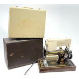 Two cased singer sewing machines.