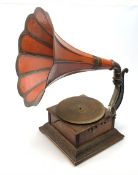 A wind up gramophone with red painted tin plate horn