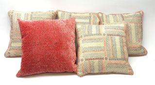 A set of four scatter cushions in a pink and grey chevron panelled cream ground fabric with pink and