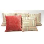 A set of four scatter cushions in a pink and grey chevron panelled cream ground fabric with pink and