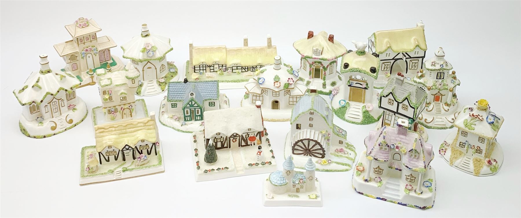 A collection of Coalport pastille burners modelled in the form of cottages and various buildings