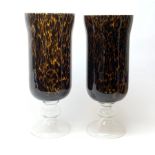 Two large glass hurricane lamps