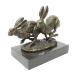 A bronze figure group, modelled as two hares in chase,