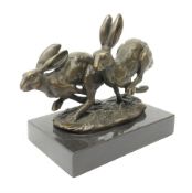 A bronze figure group, modelled as two hares in chase,