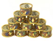 A set of ten Kingsley Enamel fruit painted napkin rings with gold coloured mounts