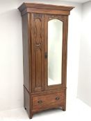 Edwardian walnut narrow single wardrobe, projecting cornice over single bevelled mirror glazed door,