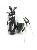 A quantity of TaylorMade golf clubs and others and two bags