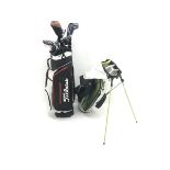 A quantity of TaylorMade golf clubs and others and two bags