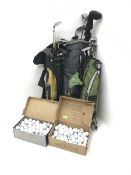 Three bags of golf clubs and two boxes of golf balls