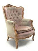 20th century beech framed French style armchair, the shaped and moulded frame carved with foliate ca