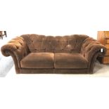 Three seat sofa, shaped cresting rail, scrolling arms, upholstered in a chocolate fabric