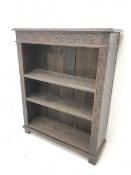 Victorian heavily carved oak bookcase, rectangular top with carved and moulded edge, flower head lun