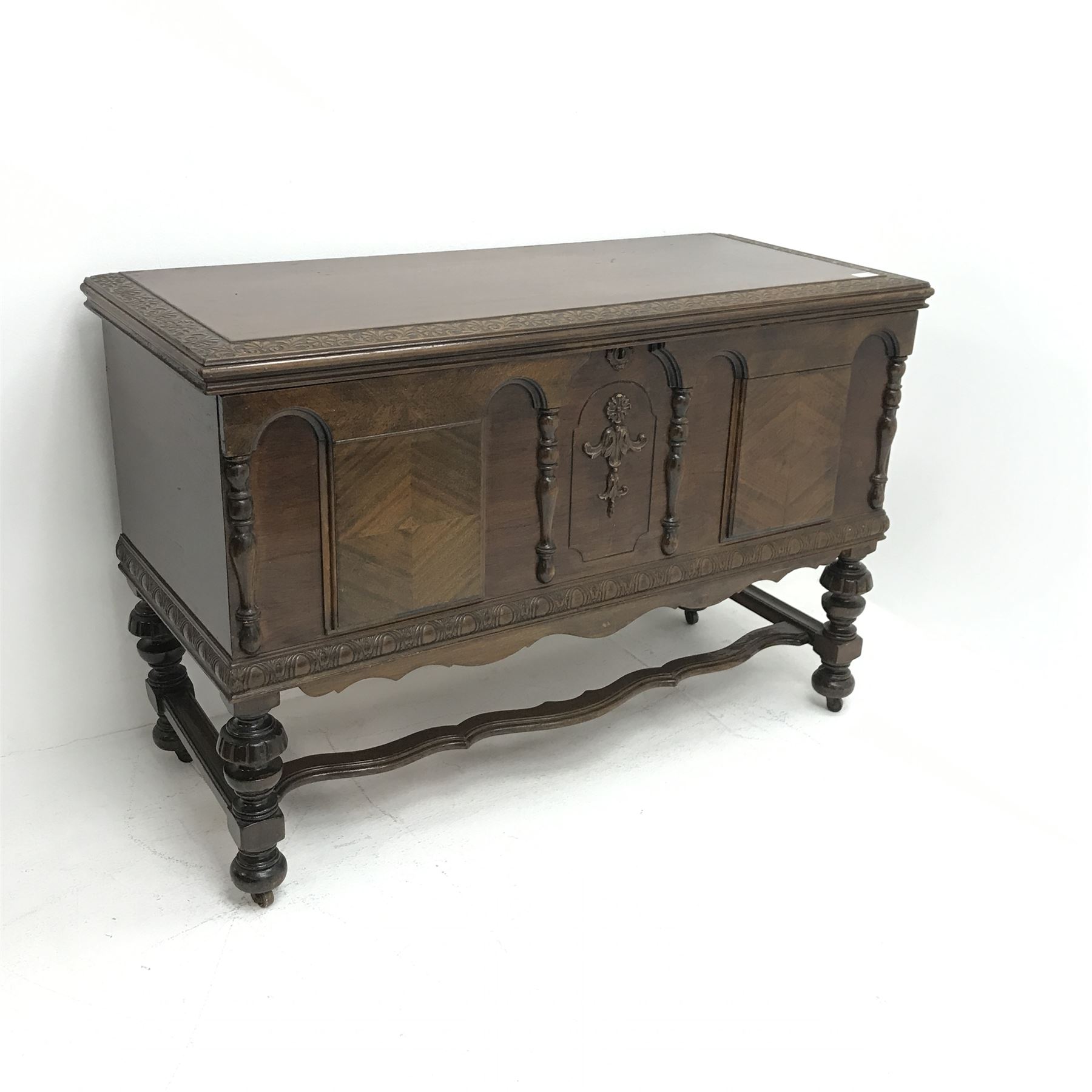 20th century walnut blanket chest, hinged top with relief carved foliate banding, on turned and carv