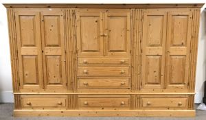 Large solid pine dress cupboard, projecting cornice, four cupboard doors, six graduating drawers, pl