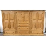 Large solid pine dress cupboard, projecting cornice, four cupboard doors, six graduating drawers, pl