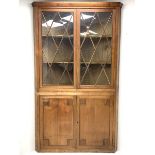 Large late 19th century sycamore corner cabinet, the top section with two astragal glazed doors encl