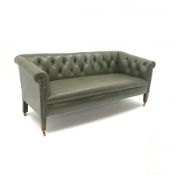 Low back settee upholstered in buttoned green leather, square tapering supports with brass cups and