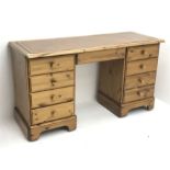 Polished pine twin pedestal desk, moulded rectangular top with inset leather, seven drawers and doub