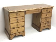 Polished pine twin pedestal desk, moulded rectangular top with inset leather, seven drawers and doub