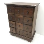 Stained hardwood haberdashery style chest, twelve drawers, shaped platform base, W70cm, H92cm, D42cm