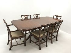 Wade Georgian style mahogany twin pedestal extending dining table, turned supports on shaped brass c