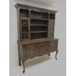 Early 20th century oak dresser, raised three tier plate rack flanked by lead glazed display cabinets