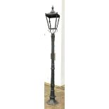 Victorian style black painted cast iron street lamp, tapering lantern with pointed finials, on stepp