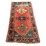 Turkish red ground rug, the field decorated with three large stylised stars, two bird motifs to one