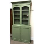 19th century and later painted pine cupboard, projecting cornice, two glazed doors enclosing three s